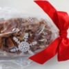 Pecan Log Packaged in Snowflake Bag with Red Bow